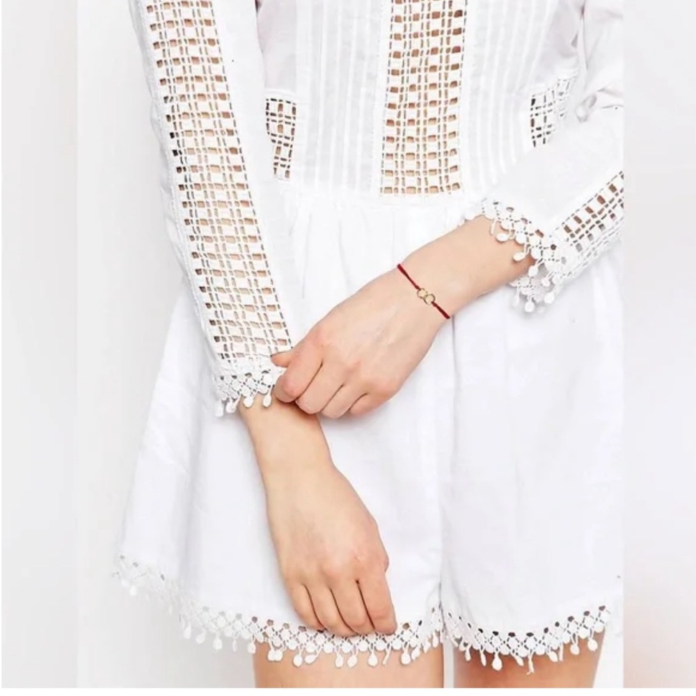 ASOS white cut-out long sleeve romper with crochet detail